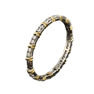 Two-tone gold and silver band ring featuring sparkling stones and X-shaped metal accents