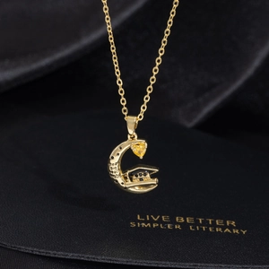 Golden graduation necklace with crescent moon and doctoral cap on black silk