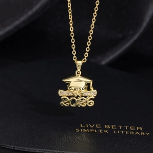 Close-up of gold graduation necklace with 2026 charm and sparkling stone details