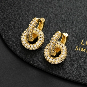 Sparkling gold circular hoop earrings with pave cubic zirconia on black display card