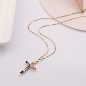 Detail view of gold cross pendant with multi-color teardrop-shaped cubic zirconia stones