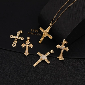 Detail of five gold-plated cross pendants with micro-pave cubic zirconia and religious motifs