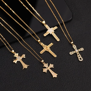 Detailed view of five distinct gold cross necklaces with micro-pave cubic zirconia on black base