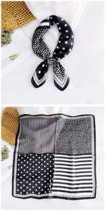 Détail d'un foulard carré en soie avec motifs géométriques noirs et blancs et pois élégants