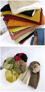 Close-up of thick ribbed knit scarves in a variety of vibrant colors for winter