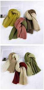 Close-up of thick knitted scarves in various colors including yellow and green