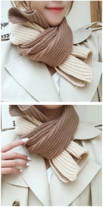 Close-up of thick knit two-tone scarf in dark coffee and cream white for winter