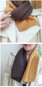 Detail of chunky knit scarf in coffee and mustard yellow showing dual-tone texture