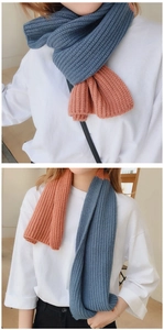 Detail of blue and orange two-tone chunky knit scarf with vertical ribbed texture