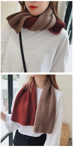 Detail showing red-brown and beige two-tone knit scarf with ribbed texture on a model