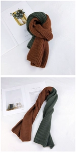 Detail view of thick ribbed knit texture on a two-tone brown and green winter scarf