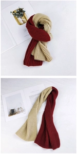 Detail of chunky knit two-tone scarf with burgundy and beige vertical ribbing texture