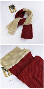 Detail of red and beige thick ribbed knit scarf showing high-quality wool texture