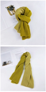 Detail of chunky rib-knit winter scarf in mustard yellow and olive green colors