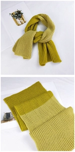 Detail of chunky ribbed knit scarf showing mustard green and lime gradient texture