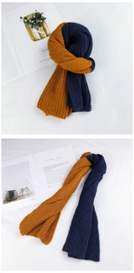 Detail of two-tone ginger and navy knit scarf showing chunky texture and stitching