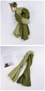 Close-up of dual-tone green chunky knit scarf with a soft texture and ribbed design