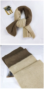 Close-up of two-tone knit scarf texture in brown and beige with thick wool weave