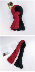 Close-up of two-tone chunky knit scarf in deep red and dark green thick warm material