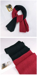 Detailed macro of thick rib knit texture on two-tone dark green and wine red scarf