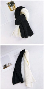 Detail of black and white two-tone thick knit scarf with ribbed texture for winter