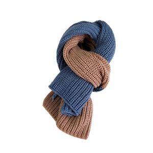 Two-tone knitted scarf in navy and brown featuring a thick ribbed weave for winter warmth