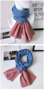 Detail of navy blue and dusty pink two-tone rib-knit scarf showing soft texture