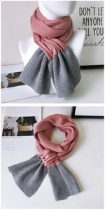Detail of pink and grey two-tone knit scarf showing soft texture and stitch patterns