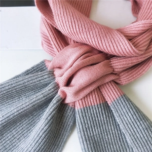 Two-tone pink and grey ribbed knit scarf with a soft crisscross design for winter warmth