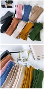 Detailed knit texture of multi-color ribbed arm warmers for autumn and winter fashion