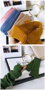 Close-up of colorful ribbed knit arm warmers in blue, pink, and khaki for autumn