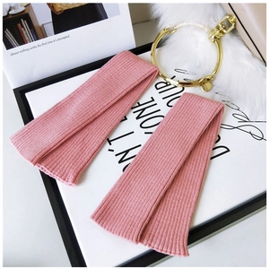 Detailed texture of pink ribbed knit arm sleeves with soft elastic wrist cuffs
