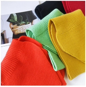 Close-up of thick knit winter scarf showing ribbed texture and vibrant colors