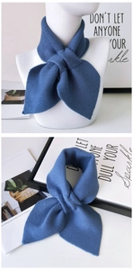 Detailed knit texture and styling of a navy blue cross-over winter neck warmer scarf