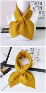 Detail of bright yellow knit scarf showing thick ribbed texture and crossover design