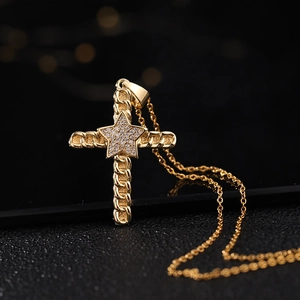 Detailed view of a gold cross pendant with micro-pave zircon star on a black base