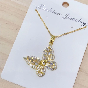 Close-up of golden butterfly pendant necklace with sparkling cubic zirconia stones