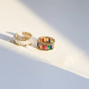 Gold ear cuffs with rainbow baguette-cut cubic zirconia and micro-bead edges