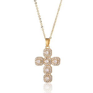 Classic gold cross pendant necklace with sparkling micro-pave crystals on white background