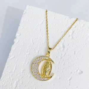 Gold crescent moon necklace with Guadalupe pendant and micro-paved cubic zirconia stones