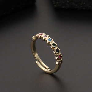 Close-up of golden adjustable ring featuring colorful zircon stones in star settings