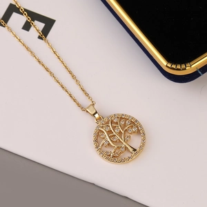 Close-up of golden Tree of Life necklace featuring pavé-set cubic zirconia on a cable chain
