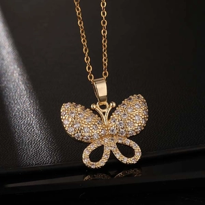 Détail d'un pendentif papillon doré serti de zircons étincelants sur chaîne fine