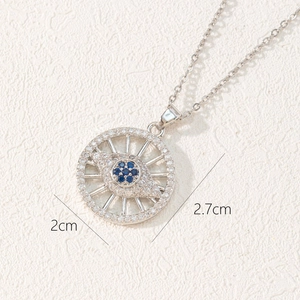 Detailed view of evil eye pendant with blue gemstone and white zircons showing 2cm diameter