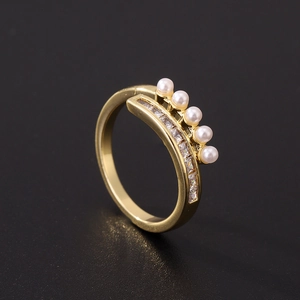 Detail of gold-plated open ring featuring five white pearls and rows of cubic zirconia