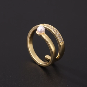 Detail view of double-layered gold-plated ring with white pearl and paved zircon crystals