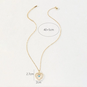 Dettaglio del ciondolo a cuore malocchio dorato con misure di 2,7 cm e 2 cm di larghezza