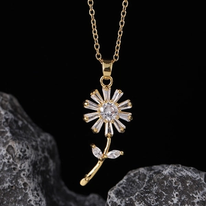 Macro shot of gold daisy pendant featuring marquise-cut zircons on a delicate chain