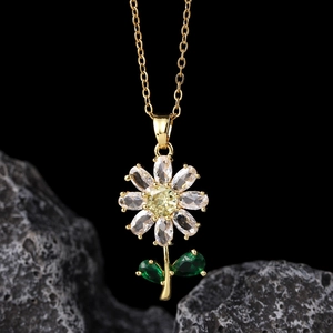 Detailed macro view of golden daisy pendant with yellow and clear zircon stones