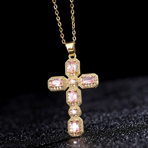 Collier croix dorée orné de pierres roses baguettes et cristaux en micro-pavage